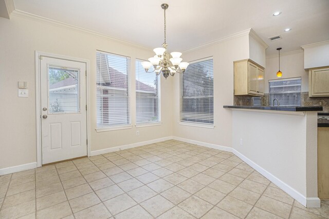 kitchen featuring a notable chandelier, ornamental molding, and tasteful backsplash