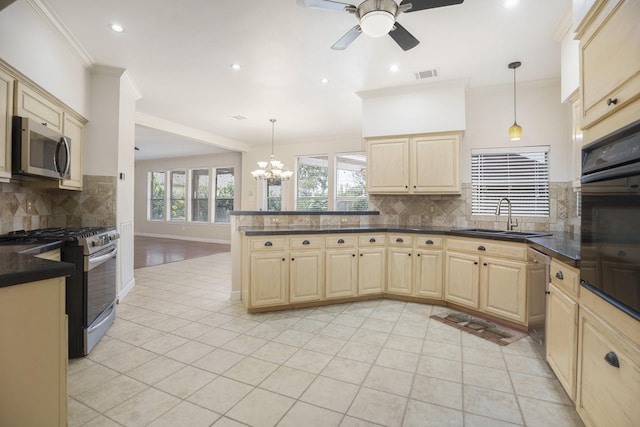 kitchen featuring sink, appliances with stainless steel finishes, backsplash, and hanging light fixtures