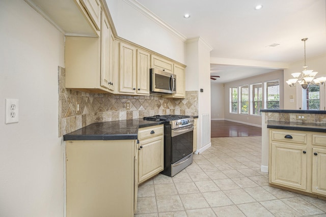 kitchen featuring stainless steel appliances, tasteful backsplash, ceiling fan with notable chandelier, hanging light fixtures, and crown molding