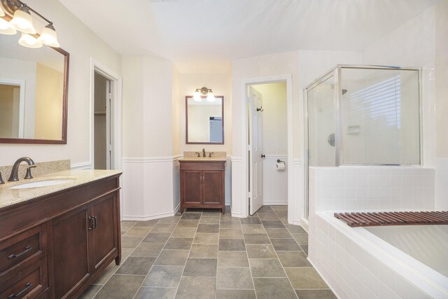 bathroom with vanity and separate shower and tub