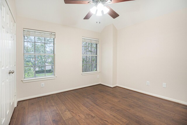 unfurnished room with a healthy amount of sunlight, dark hardwood / wood-style flooring, and ceiling fan