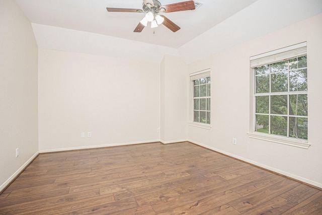 empty room with ceiling fan, vaulted ceiling, and wood-type flooring