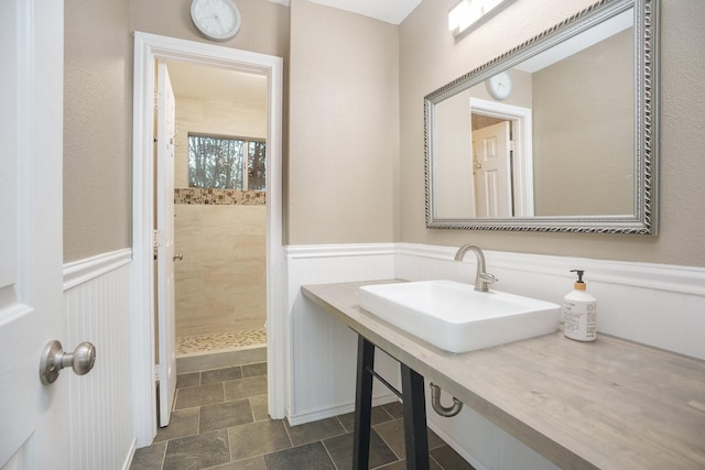 bathroom featuring sink and a tile shower