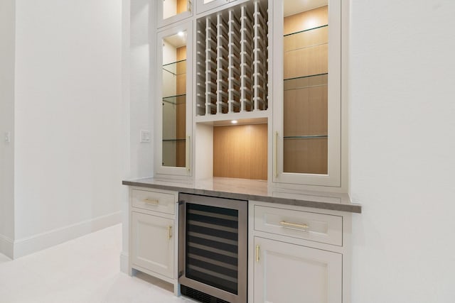 bar with white cabinets and wine cooler