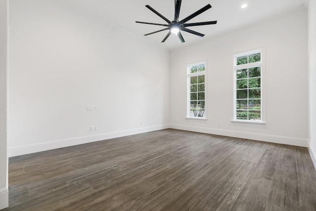 empty room featuring ceiling fan and dark hardwood / wood-style flooring