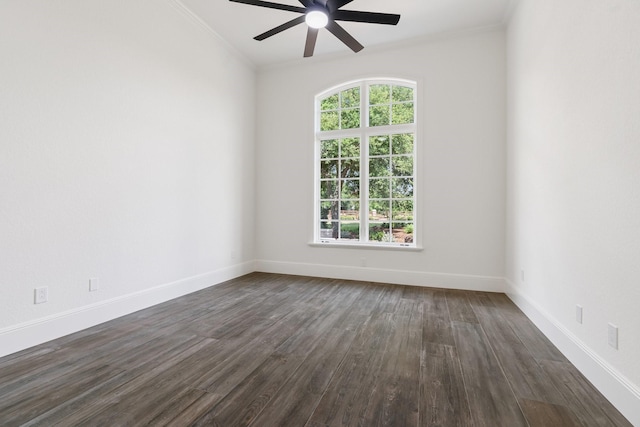 empty room with ceiling fan, a wealth of natural light, crown molding, and dark wood-type flooring