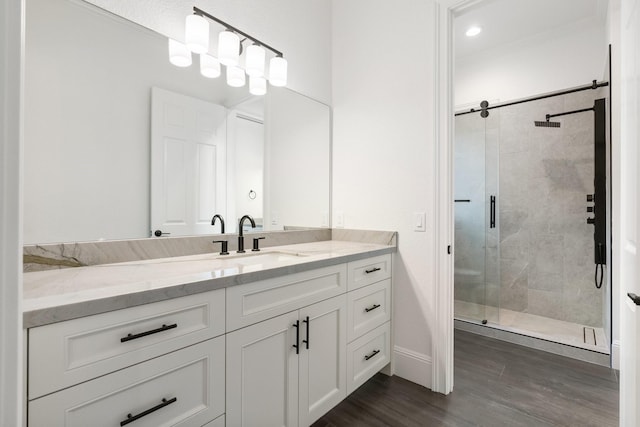 bathroom featuring an enclosed shower, vanity, hardwood / wood-style floors, and crown molding