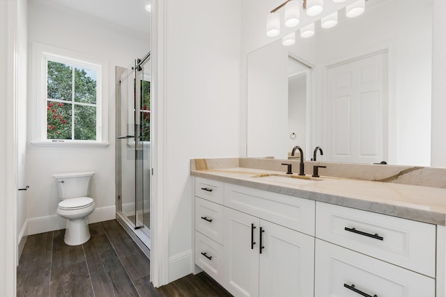 bathroom with toilet, vanity, walk in shower, and hardwood / wood-style floors