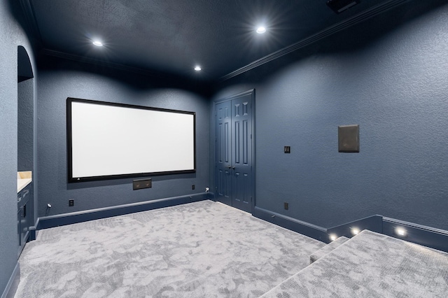 carpeted home theater room with crown molding