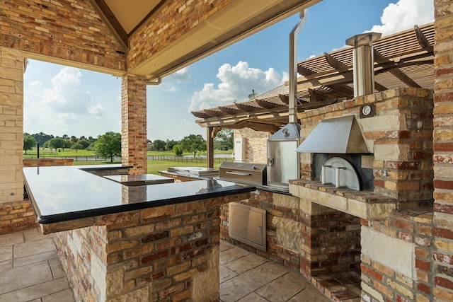 view of patio with exterior kitchen and grilling area