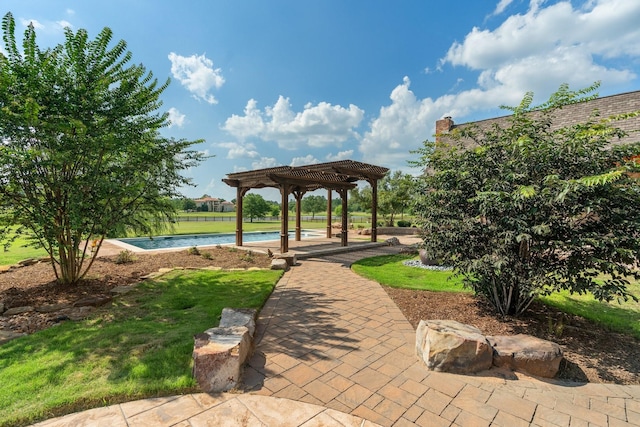 view of community with a pool, a patio area, a lawn, and a pergola