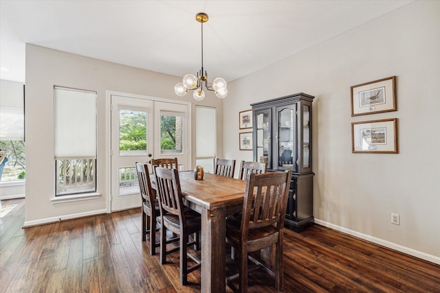 dining area featuring french doors, a notable chandelier, and dark hardwood / wood-style flooring