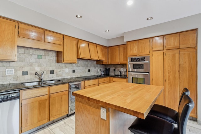 kitchen with stainless steel appliances, sink, a center island, tasteful backsplash, and wine cooler