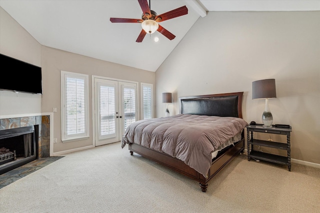 bedroom featuring a tile fireplace, carpet floors, ceiling fan, beam ceiling, and access to outside