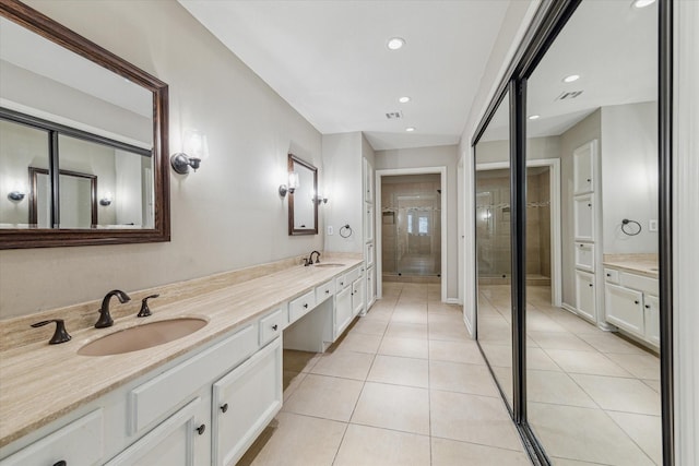 bathroom featuring tile patterned flooring, a shower with door, and vanity