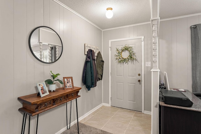 tiled entryway featuring a textured ceiling, wood walls, and crown molding