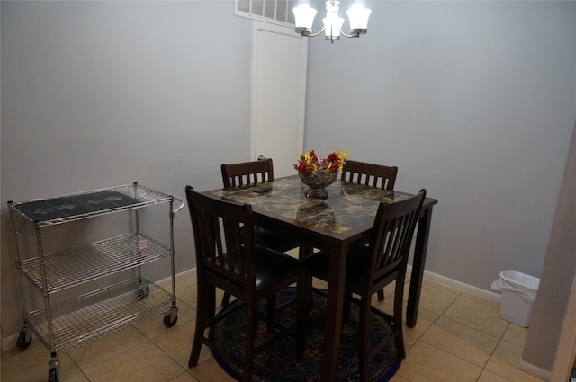 dining room featuring light tile patterned floors and a chandelier