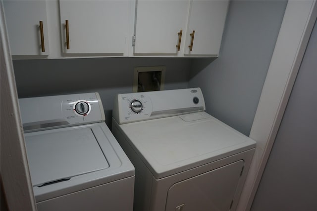 washroom featuring washer and dryer and cabinets