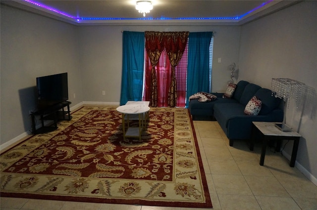 tiled living room featuring a raised ceiling