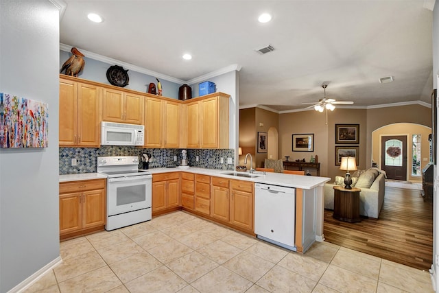 kitchen featuring white appliances, kitchen peninsula, light tile patterned floors, ceiling fan, and sink