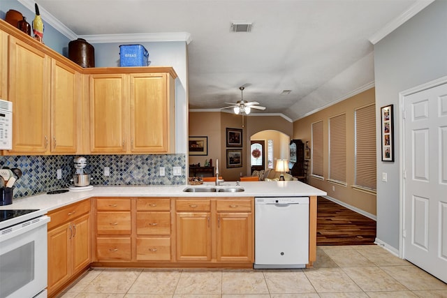 kitchen featuring white appliances, kitchen peninsula, backsplash, ceiling fan, and sink