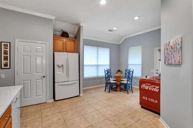 kitchen featuring white appliances, light tile patterned flooring, ornamental molding, and lofted ceiling