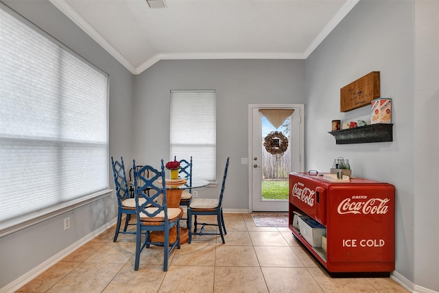 dining area with lofted ceiling, light tile patterned flooring, and crown molding