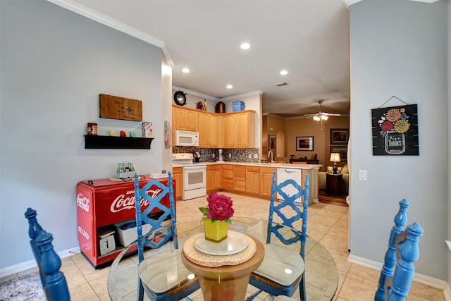 dining space with ceiling fan, crown molding, light tile patterned flooring, and sink