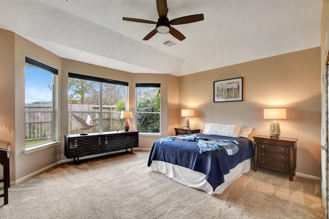 bedroom with light colored carpet, ceiling fan, and multiple windows