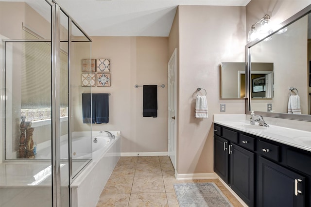 bathroom featuring a washtub, tile patterned floors, and vanity