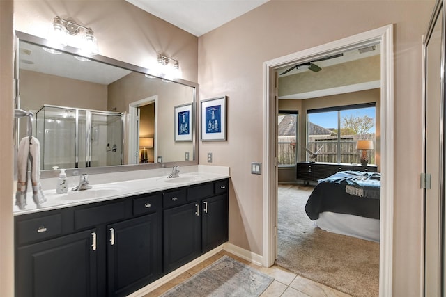 bathroom with a shower with door, tile patterned flooring, and vanity