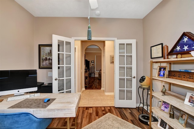 office with ceiling fan, french doors, and wood-type flooring