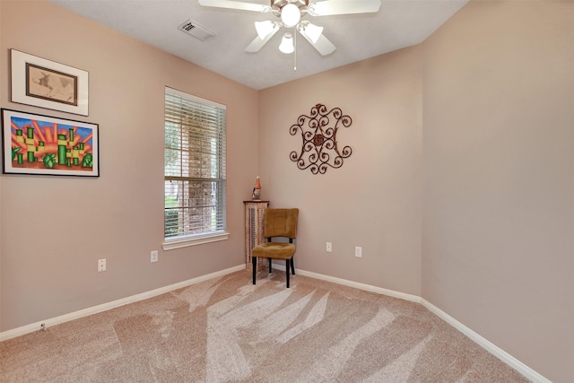 living area with carpet, ceiling fan, and plenty of natural light