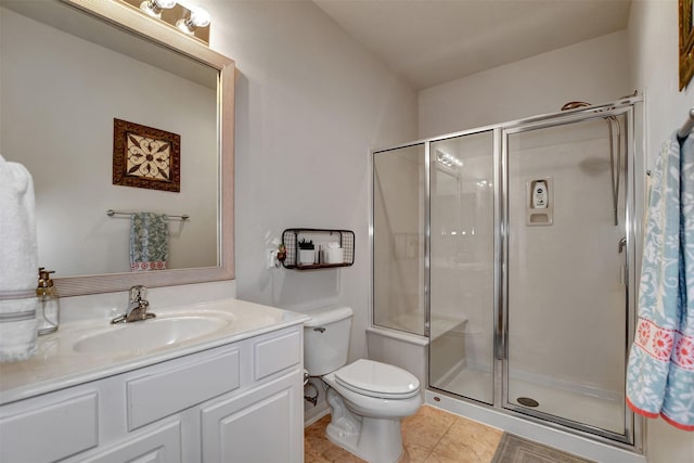 bathroom featuring a shower with door, tile patterned flooring, vanity, and toilet