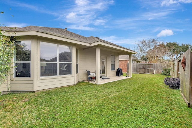 rear view of property featuring a patio area and a lawn