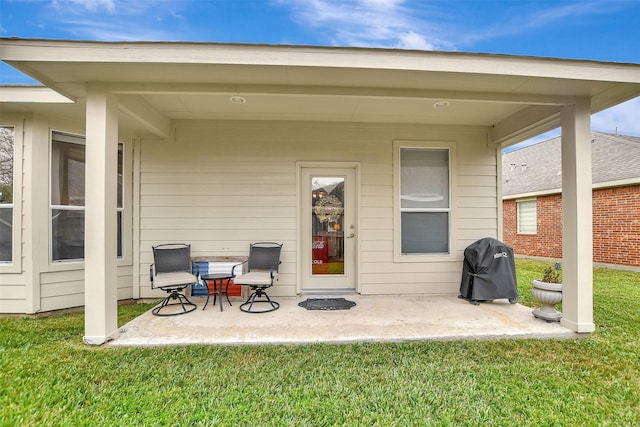 back of property featuring a patio and a yard