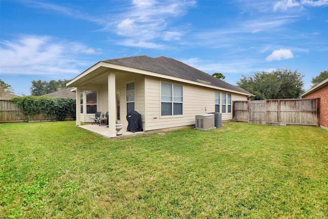 rear view of house with a patio area and a yard