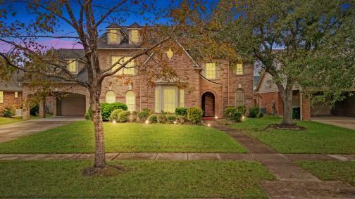 view of front of property with a lawn and a garage