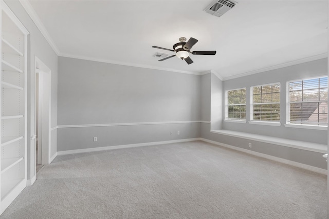 carpeted spare room with ornamental molding and ceiling fan