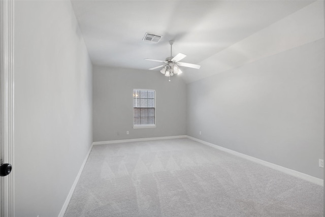 carpeted empty room featuring ceiling fan and vaulted ceiling