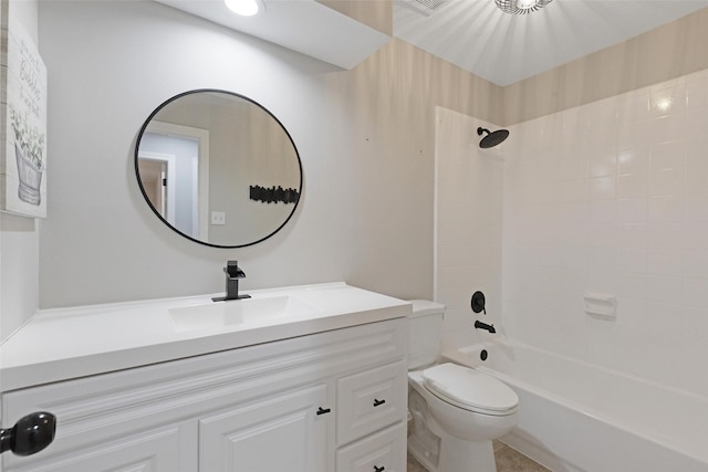 full bathroom with toilet, vanity, and tiled shower / bath