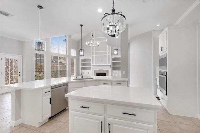 kitchen featuring appliances with stainless steel finishes, white cabinetry, sink, and a kitchen island