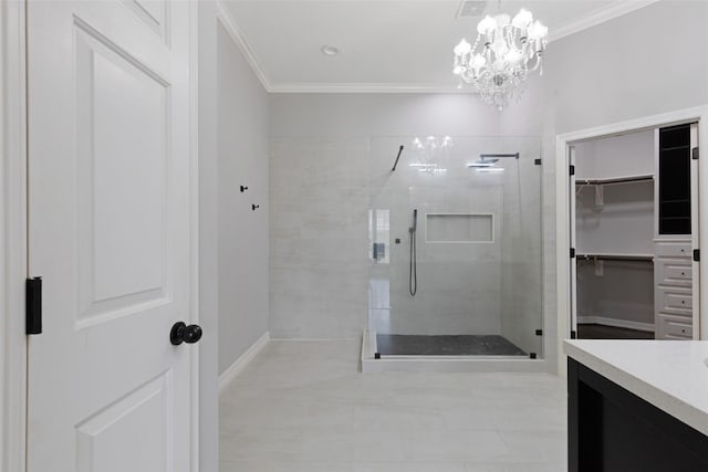 bathroom featuring a notable chandelier, crown molding, tiled shower, and vanity