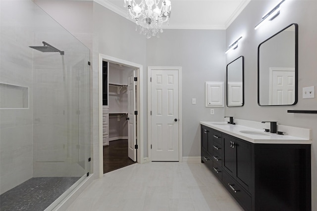 bathroom with walk in shower, vanity, an inviting chandelier, and crown molding