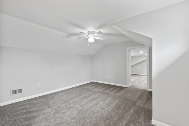 bonus room with lofted ceiling, dark colored carpet, and ceiling fan