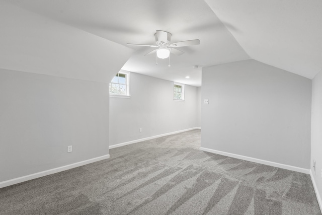 additional living space featuring carpet flooring, ceiling fan, and vaulted ceiling