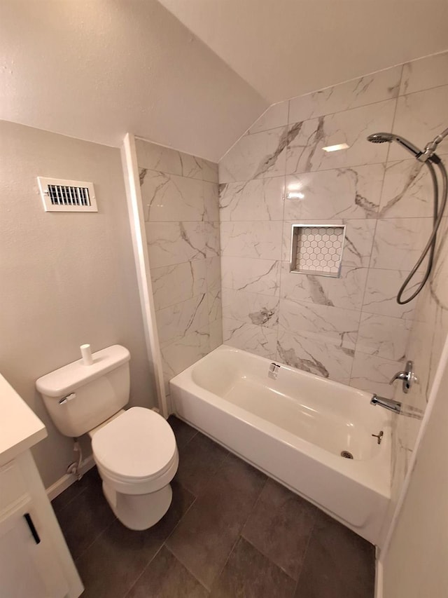 full bathroom with vanity, lofted ceiling, tiled shower / bath combo, and toilet