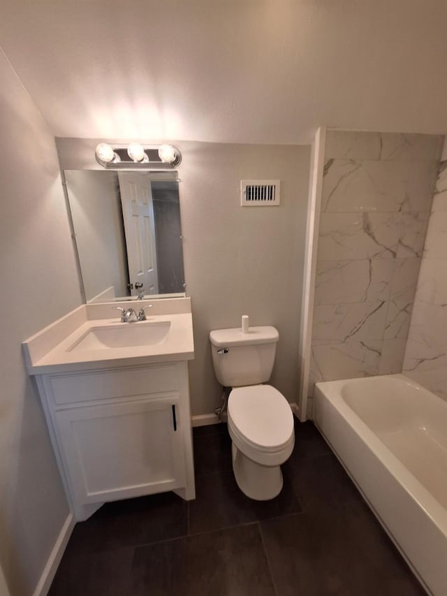 full bathroom featuring toilet, vanity, and tiled shower / bath