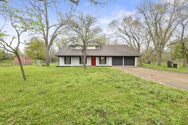 view of front of property with a front lawn and a garage