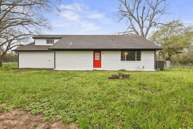 rear view of house with a yard